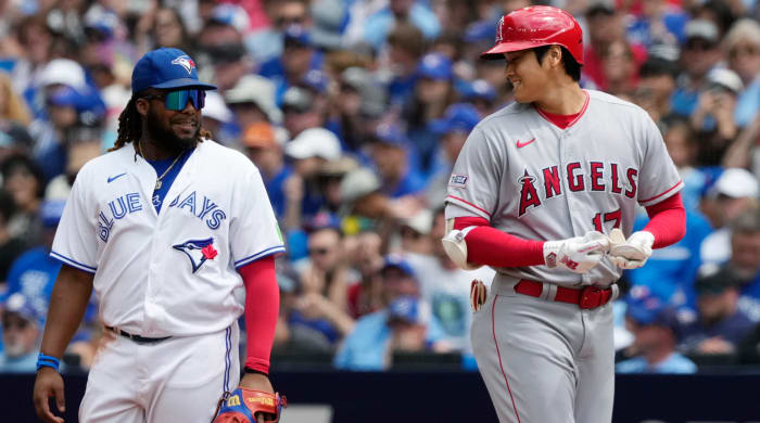 Angels designated hitter Shohei Ohtani (right) talks to Blue Jays first baseman Vladimir Guerrero Jr.